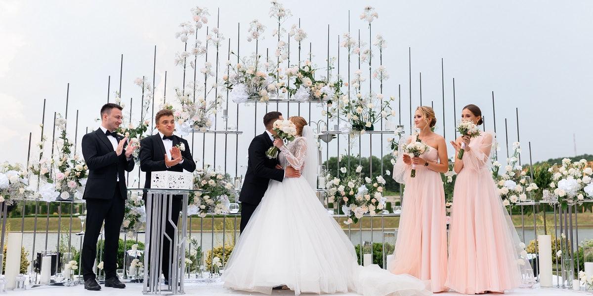 bridesmaids in pink and groomsmen in black