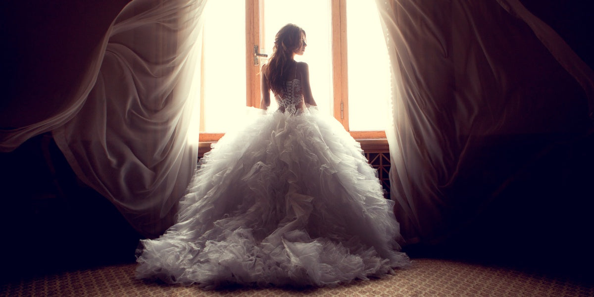 Portrait of beautiful bride against window indoors